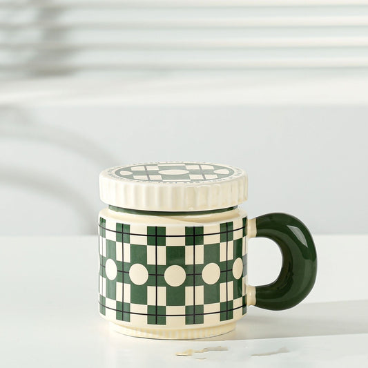 Modern checkered ceramic coffee mug with green handle